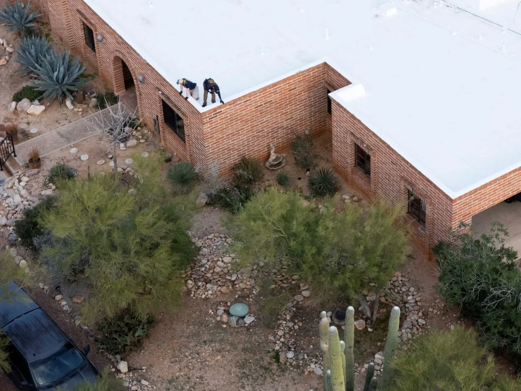 Investigators removing device from Nancy's roof.