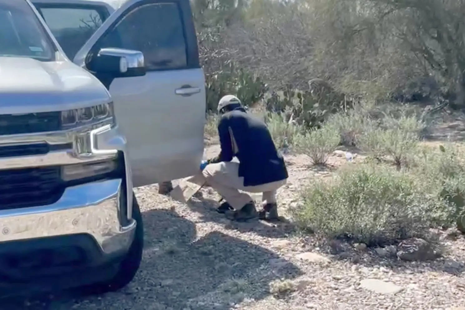 FBI officers examine glove on the ground 1.5 miles from Nancy Guthrie’s home.