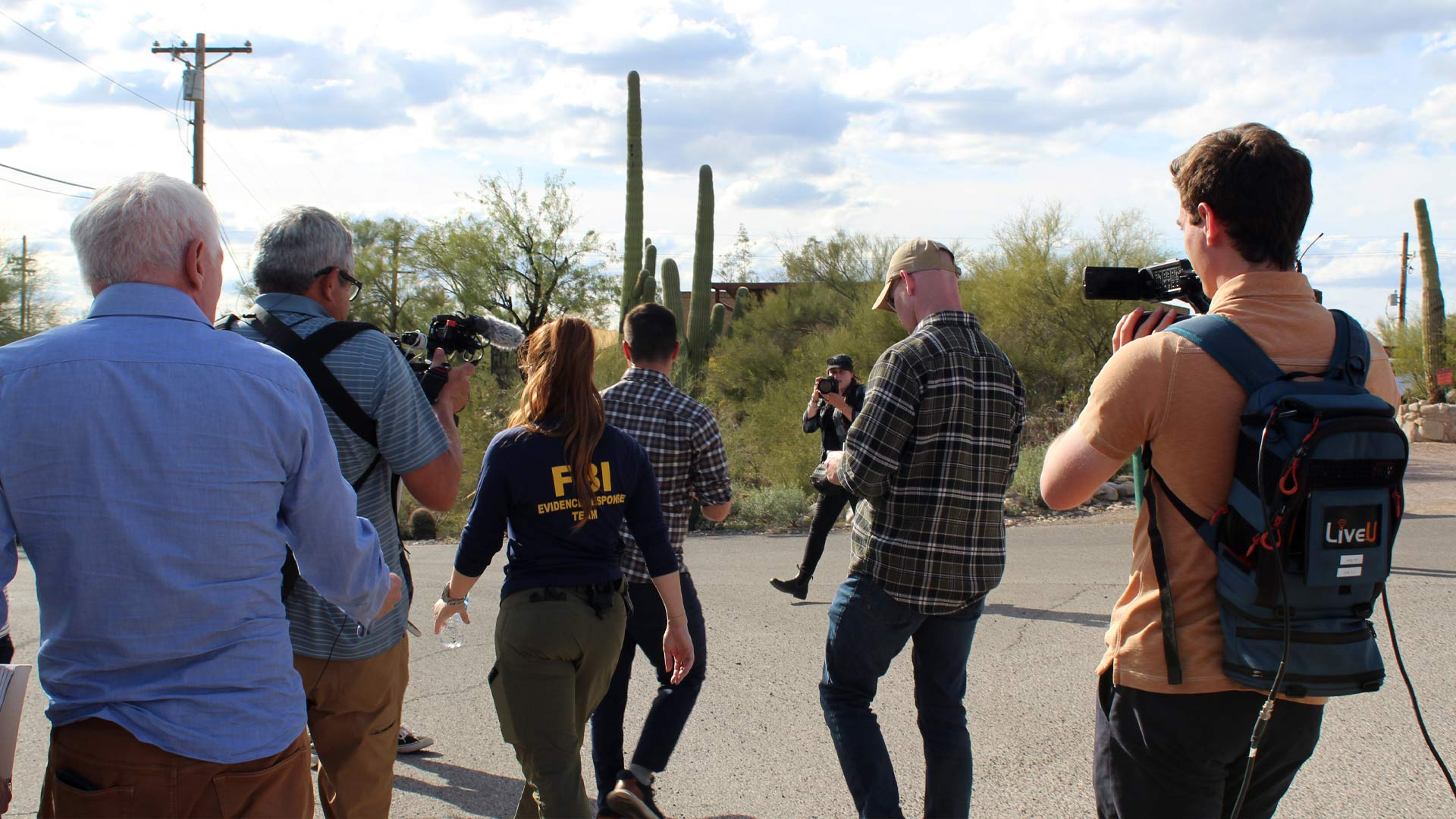 Media closely following FBI investigators around Nancy's home.