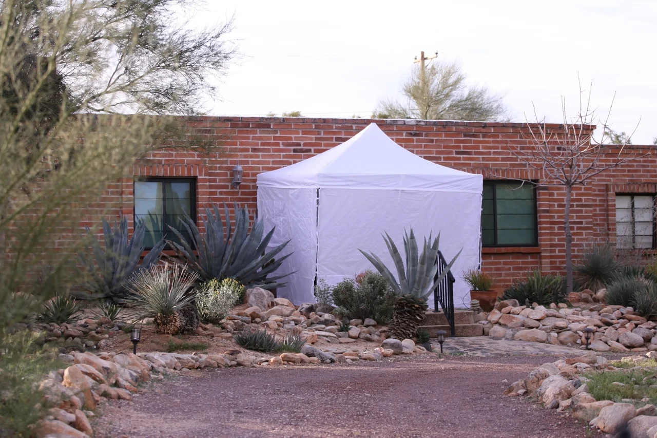 A view of a tent outside of Nancy Guthrie's residence. 